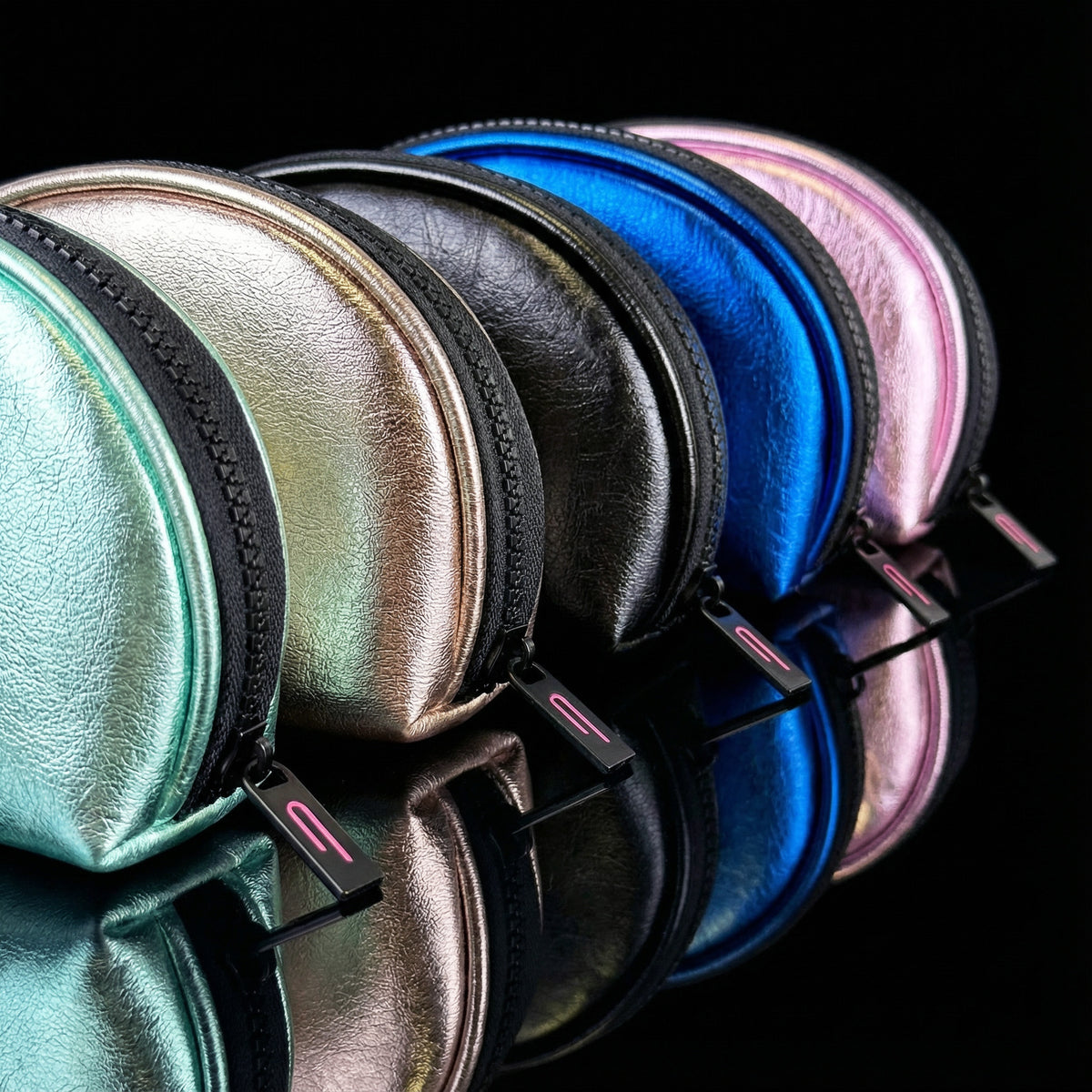 Luna LED makeup bags in Mint, Fizz, Onyx, Ocean and Pink displayed on a reflective black background.