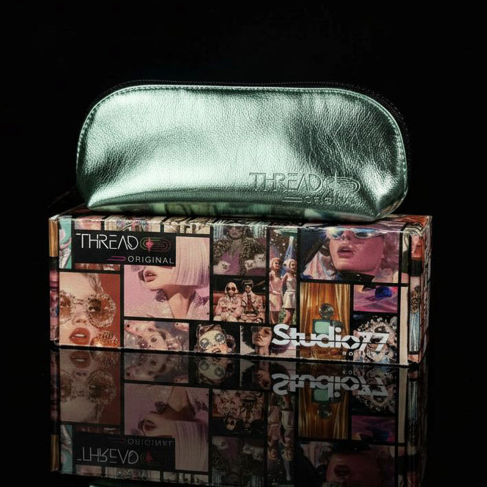 Lyra compact makeup bag in metallic Mint green, closed and resting on top of a Thread Original box.